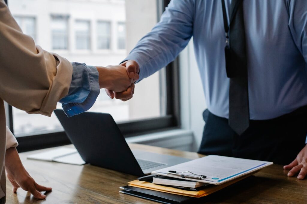 crop-colleagues-shaking-hands-in-office-5673488